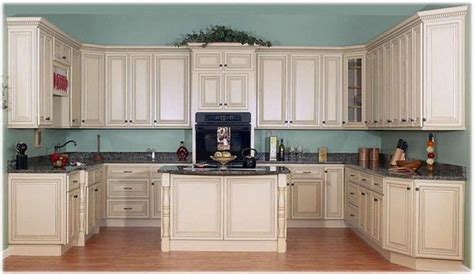 White kitchen boasts a beige wooden island topped with a white quartz countertop lit by 2 hicks pendants. Image result for white washed maple cabinets images | Antique white kitchen, Glazed kitchen ...