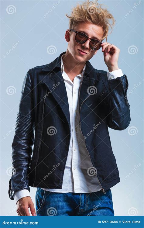 Skinny Man Taking Off His Sunglasses And Smiling At The Camera Stock