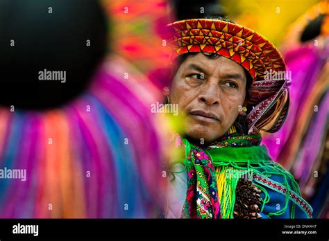 a colombian kamentsá native wearing a colorful headgear takes part in the carnival of