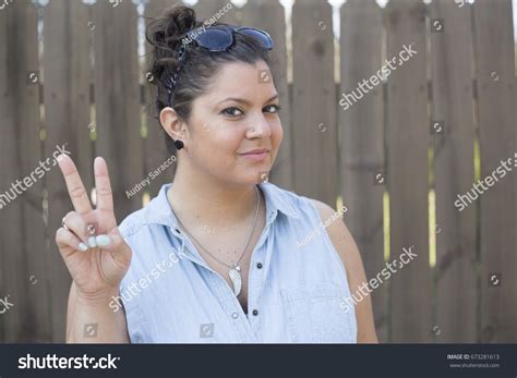 Attractive Woman Giving Peace Sign Stock Photo 673281613 Shutterstock