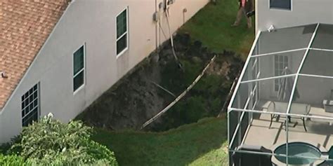 Two Florida Families Homeless Afterlarge Sinkhole Opens Up Between