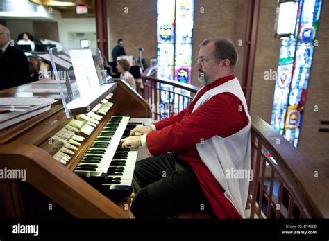 Organist Wearing Choir Robe Plays During Sunday Service At St Martins