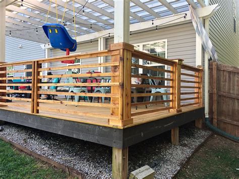 The modern wire railing is a unique and a totally different railing idea for your deck. Cedar deck railing | Cedar deck, Deck railings, Deck