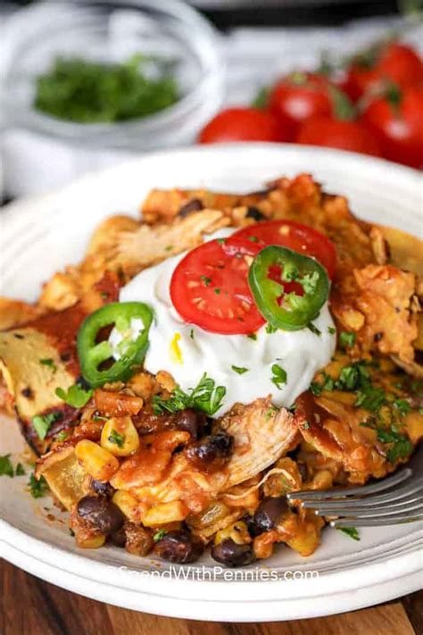 Our family loves this quick and easy crock pot chicken enchilada casserole recipe! Easy Slow Cooker Chicken Enchiladas - Spend With Pennies