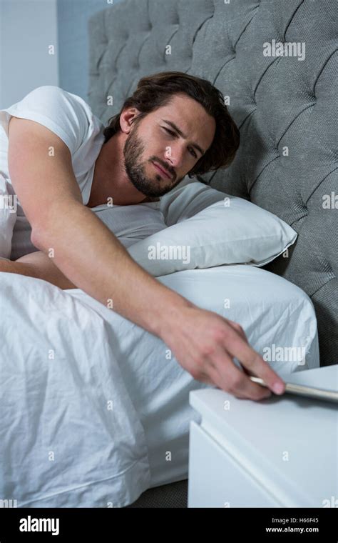 Man Waking Up With Mobile Alarm Clock Stock Photo Alamy