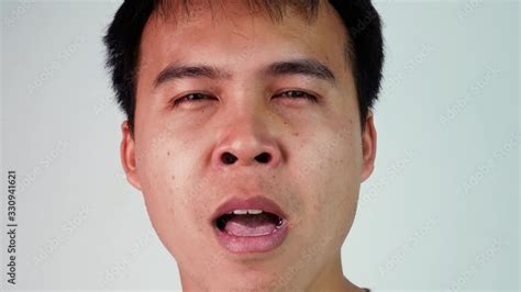 Close Up Portrait Of Tired Asian Man Expressing Drowsy And Yawn Over