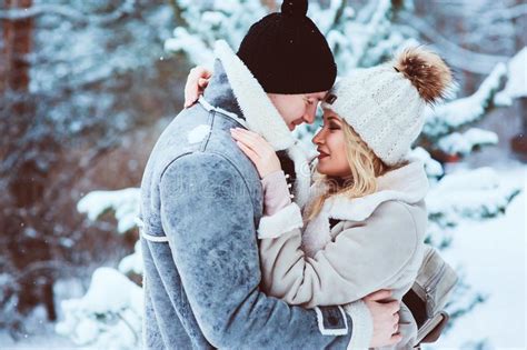 Romantic Winter Portrait Of Couple Embracing Outdoor On The Walk In Snowy Forest Stock Image