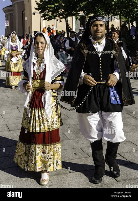 Woman And Ma Wearing A Traditional Sardinian Costume At The Religious