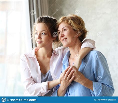 Happy Senior Mother Embracing Adult Daughter Laughing Together Stock Image Image Of Mature