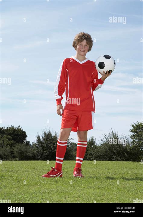 Young Male Footballer Holding A Ball Stock Photo Alamy
