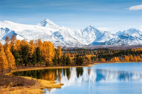 Premium Photo Kidelu Lake Snow Covered Mountains And Autumn Forest