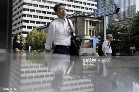 Pedestrians Walk Past The Bank Of Japan Headquarters In Tokyo Japan