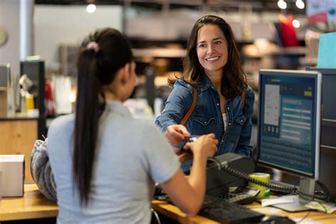 *no interest when you spend $150 or more if you pay in full within 6 months. Cheerful Female Customer Making A Contactless Payment With Credit Card At A Furniture Store ...