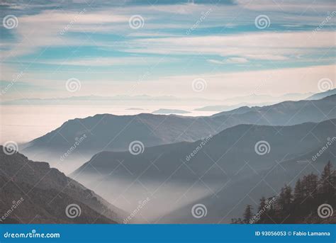 Distant Mountain Range With Fog And Mist Covering The Valleys Below