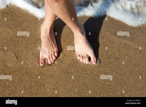 Woman S Bare Feet On Sandy Beach Stock Photo Alamy