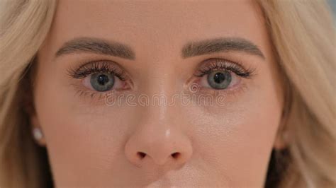 Close Up Blinking Eyes Of Young Woman Looking At Camera Stock Image
