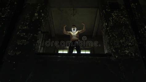 The Guy Is Standing Near A Ruined Staircase In A Forgotten Building