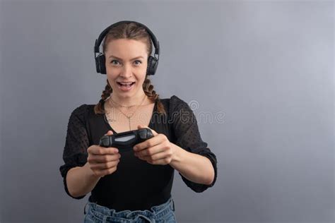 Young Beautiful Gamer Woman Playing Video Game Using Joystick And