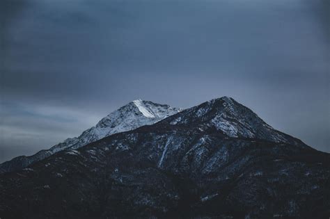 Overcast Sky Over Rocky Snowy Mountains In Winter Evening · Free Stock