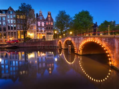 Amsterdam Netherlands View Of Houses And Bridges During Sunset The