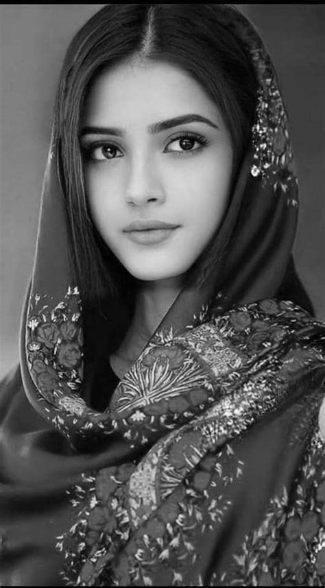 A Young Woman Wearing A Veil And Headdress Is Posing For A Photo In Black And White
