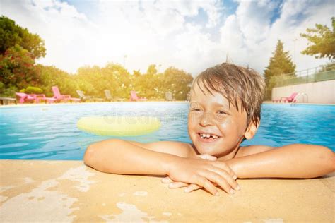 Happy Boy Relaxing At The Swimming Pool Edge Stock Photo Image Of