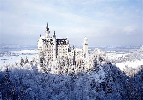 An Image Of A Castle In The Middle Of Trees Covered With Snow On A