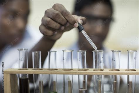 Student In Chemistry Class Pipetting Liquid Into Test Tube Stock Foto