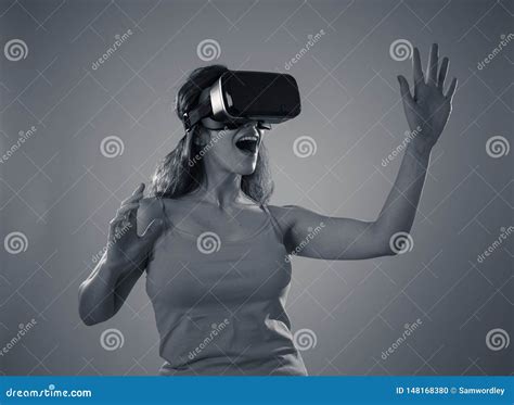 Portrait Of Cheerful And Shocked Young Woman Wearing Virtual Reality