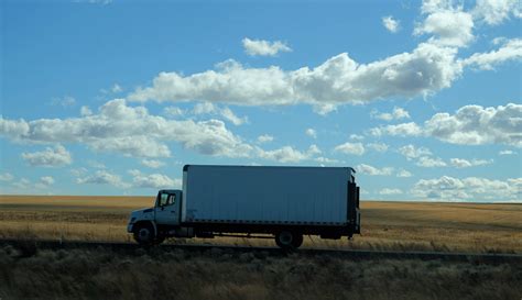 Download Trailer Truck Parked Grass Field Wallpaper