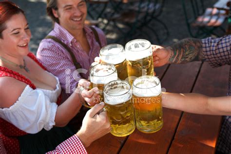 People Drinking Beer In A Traditional Bavarian Beer Garden Stock Photo