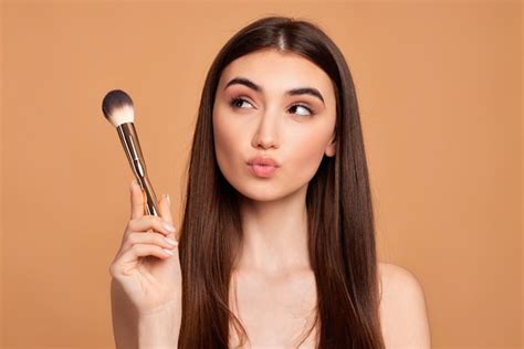 Premium Photo Beautiful Young Woman Holding Makeup Brush