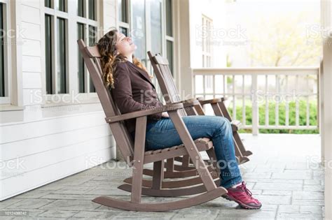 Young Woman Sitting On Reclining Rocking Chair Recliner Rocker By House