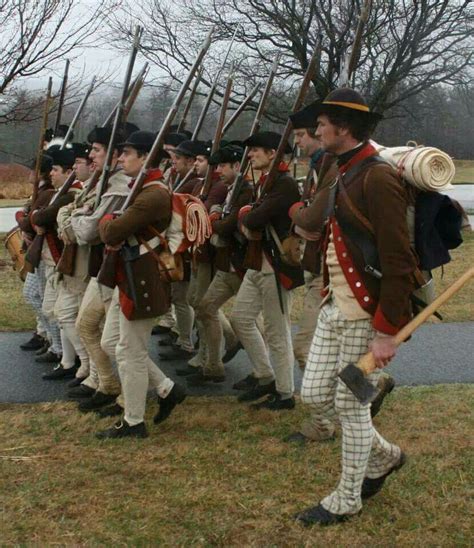 Men In Period Uniforms Marching Down The Street