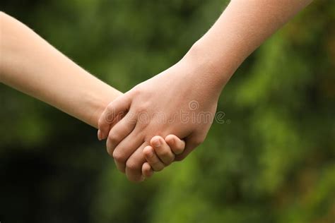 Woman And Child Holding Hands Outdoors Closeup Stock Photo Image Of