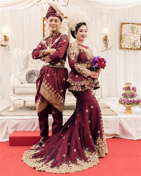 hanan and yati rocking their custom made maroon and gold songket custom made outfit designed by