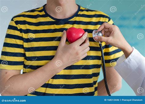 Doctor Using Stethoscope Listen Heart Beat Sound From Red Heart Plastic