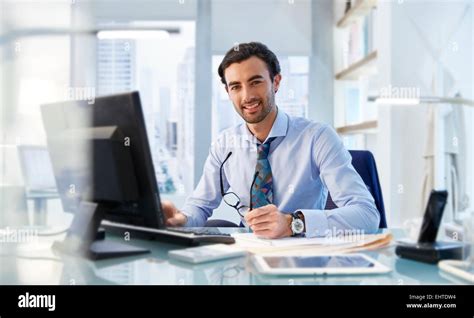 Portrait Of Man Sitting At His Desk In Office Stock Photo Alamy