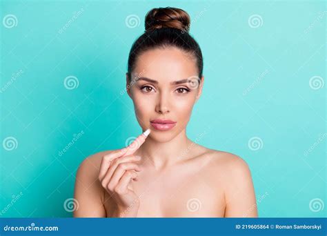 Portrait Of Attractive Naked Nude Girl Applying Lip Balm Form Correction Scrub Over Bright Teal