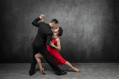 premium photo couple of professional tango dancers in elegant suit and dress pose eye to eye