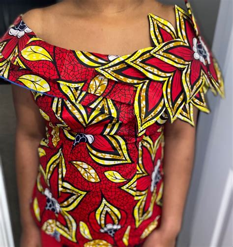 A Woman Wearing A Red And Yellow Patterned Dress