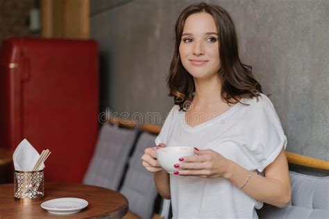 Beautiful Brunette Woman With Dreamy Expression Has Coffee Break After