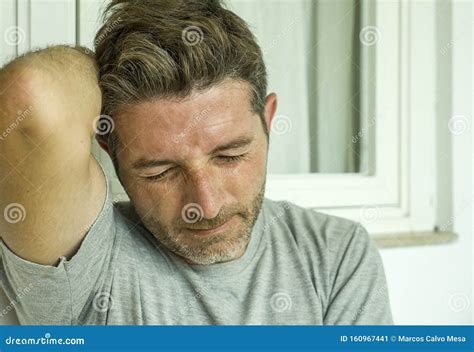 Dramatic Portrait Of Middle Aged Sad And Depressed Man In Pain Feeling