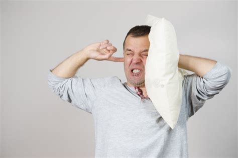 Sleepy Man With Pillow Closing His Ear Stock Photo Image Of Sleepy