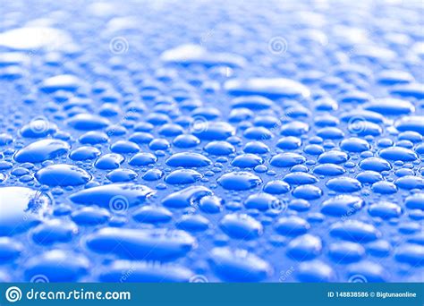 Transparent Still Water Drops On Light Blue Background. Blue Water Drops. Drops Of Rain On Glass 
