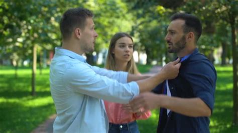 Frightened Woman Standing Between Fighting Men Rivalry For Girls Attention Stock Footage