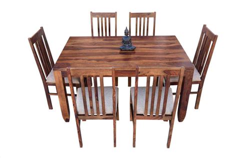 A tasteful dining set of natural finished wood. Buy 6-Seater pencil dining table with Upholstery chair ...