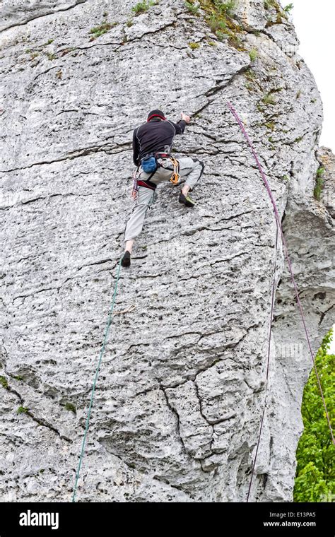 Man Climbing Steep And High Rocky Wall Stock Photo Alamy