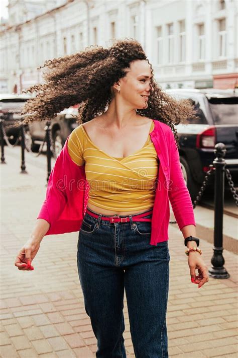 portrait of beautiful smiling model with afro curls hairstyle dressed in summer hipster clothes