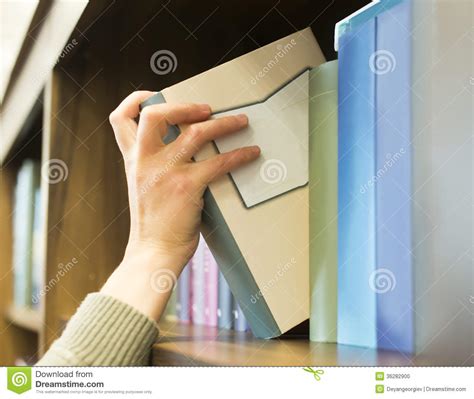 Key attributes of cots software. Hand Pulling A Book Off The Shelf Stock Photo - Image of ...